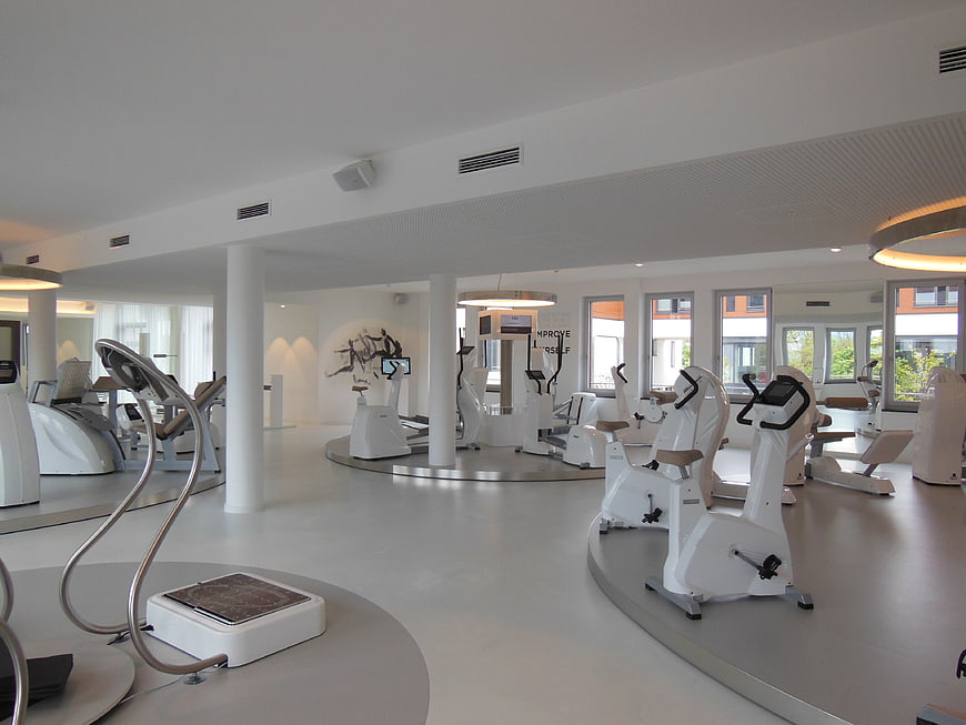 Modern luxury fitness center with white exercise equipment