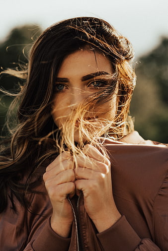 Woman with Windblown Hair in Brown Jacket