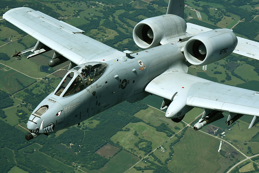A-10 Thunderbolt II Warthog in Flight Over Green Landscape
