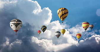 Colorful Hot Air Balloons Flying in Blue Sky with Clouds