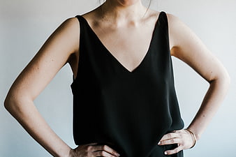 Woman in Black Sleeveless Top with Hands on Hips