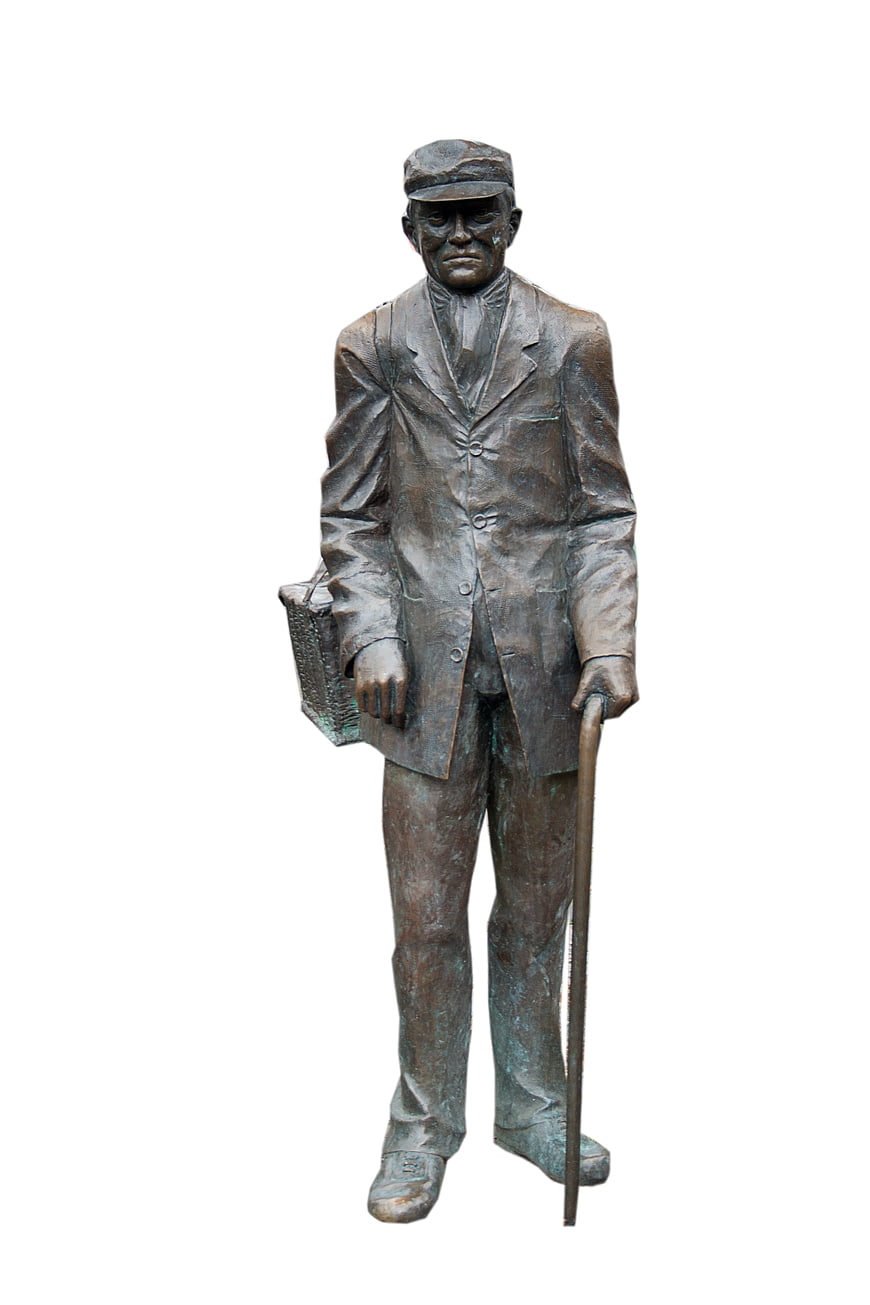 Bronze statue of elderly man with cane and briefcase
