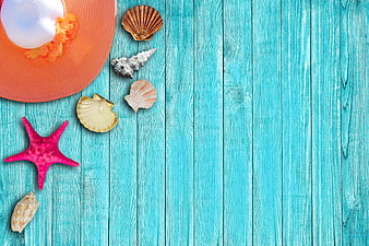 Summer vacation flat lay with seashells and hat on turquoise wood