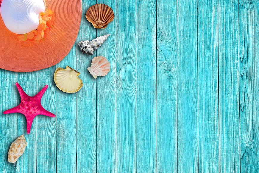 Summer vacation flat lay with seashells and hat on turquoise wood