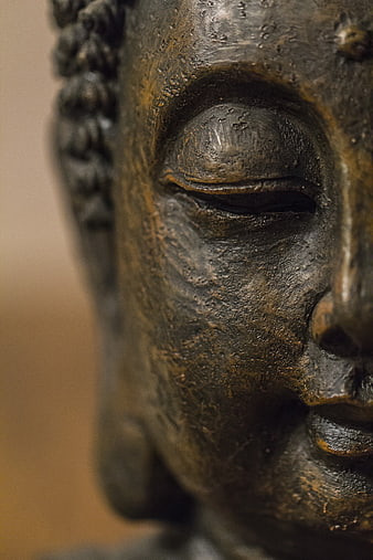 Close-up of Ancient Bronze Buddha Statue Face
