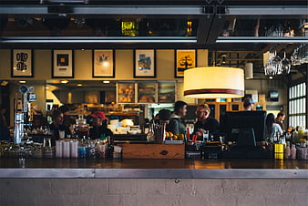 Busy restaurant bar counter with staff and customers