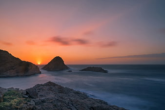 Dramatic Sunset Over Rocky Coastal Sea Stack