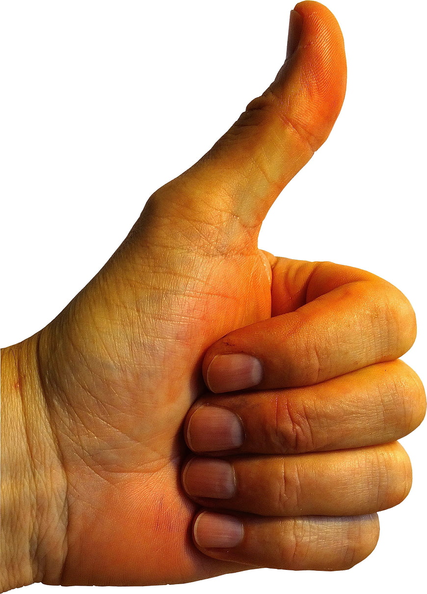 Close-up of a hand giving a thumbs up gesture on white background