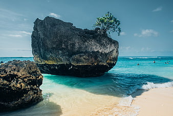 Large Rock Formation on Tropical Beach with Turquoise Water