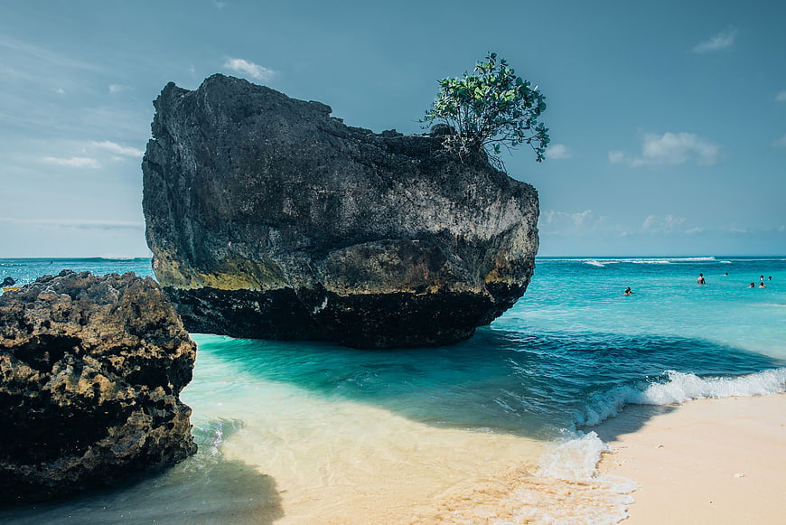 Large Rock Formation on Tropical Beach with Turquoise Water