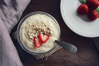 Overhead view of yogurt bowl with oats and strawberries