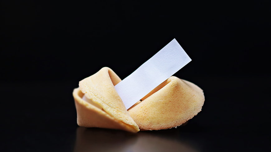 Broken Fortune Cookie with Blank Paper Strip on Black Background