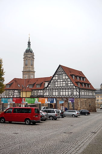 Historic half-timbered building and church tower in Eisenach, Germany