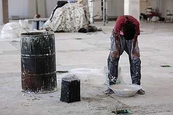 Exhausted Construction Worker Resting at Industrial Site