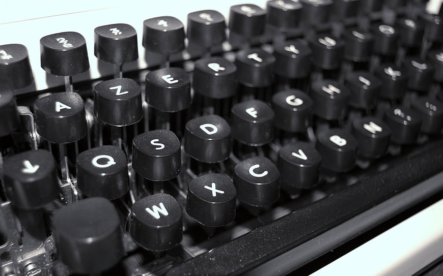 Close-up of vintage typewriter keys in black and white