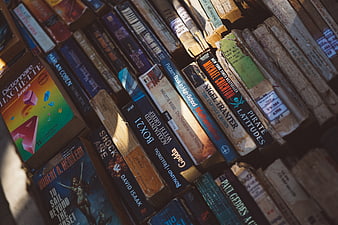Vintage Books on Shelf with Sunlight and Shadows