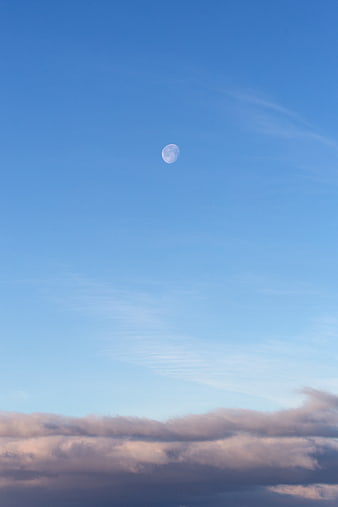 Daytime Moon in Blue Sky with Pink Clouds