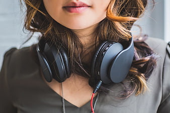 Close-up of woman with headphones around neck