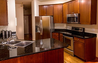 Modern kitchen with cherry wood cabinets and granite countertops