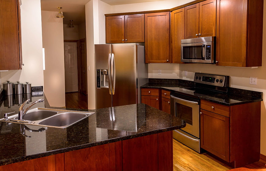 Modern kitchen with cherry wood cabinets and granite countertops