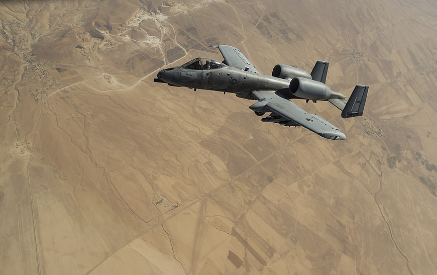 A-10 Warthog Military Jet Flying Over Desert Terrain