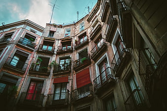 Low angle view of weathered European apartment buildings with balconies