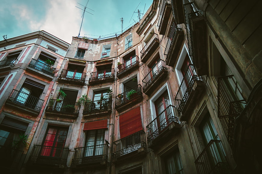 Low angle view of weathered European apartment buildings with balconies