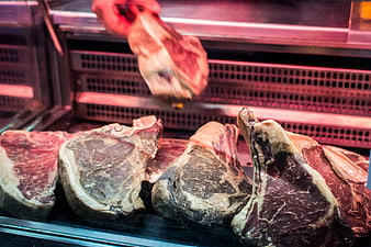 Fresh raw beef steaks in butcher shop display case