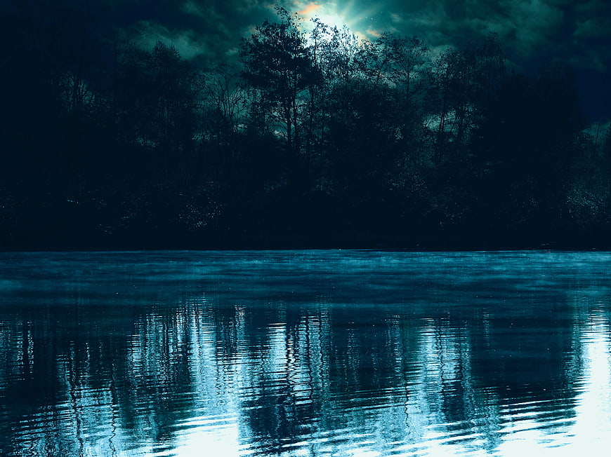 Mysterious Moonlit River with Silhouetted Trees at Night