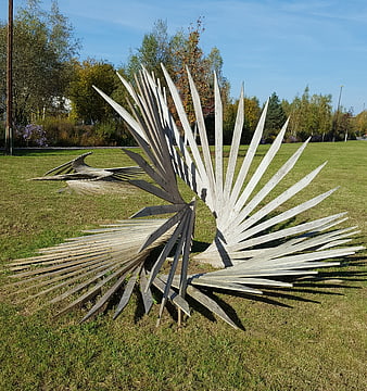 Modern wooden fan sculpture in a sunny park