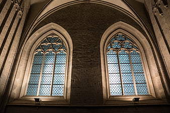 Gothic church interior with arched stained glass windows