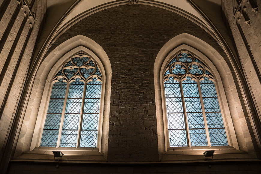 Gothic church interior with arched stained glass windows