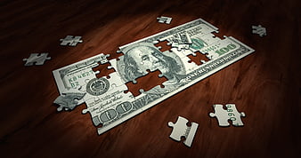 100 Dollar Bill Puzzle on Wooden Table