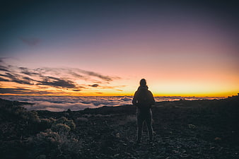 Woman Silhouette Watching Sunset Over Sea of Clouds