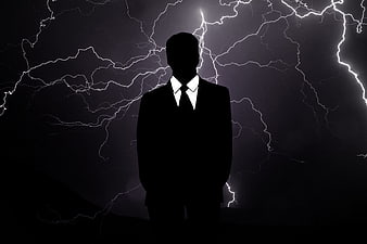 Silhouette of Businessman Against Lightning Storm Background