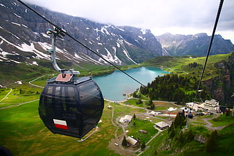 Cable car view of turquoise alpine lake and mountains