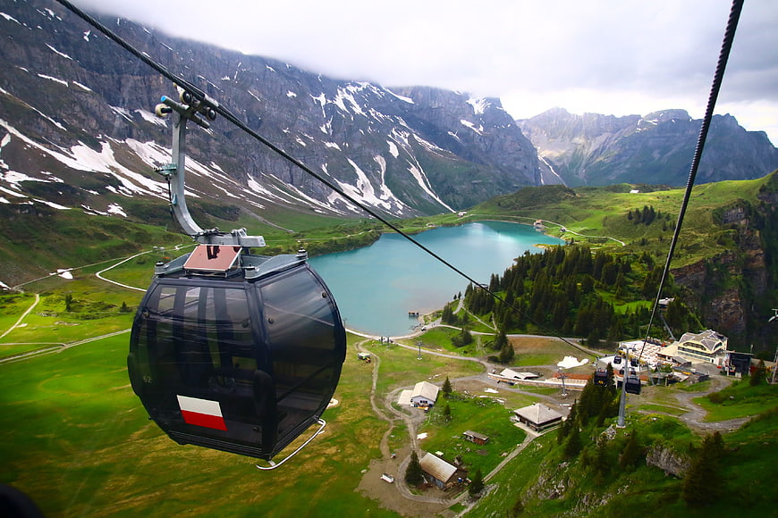 Cable car view of turquoise alpine lake and mountains