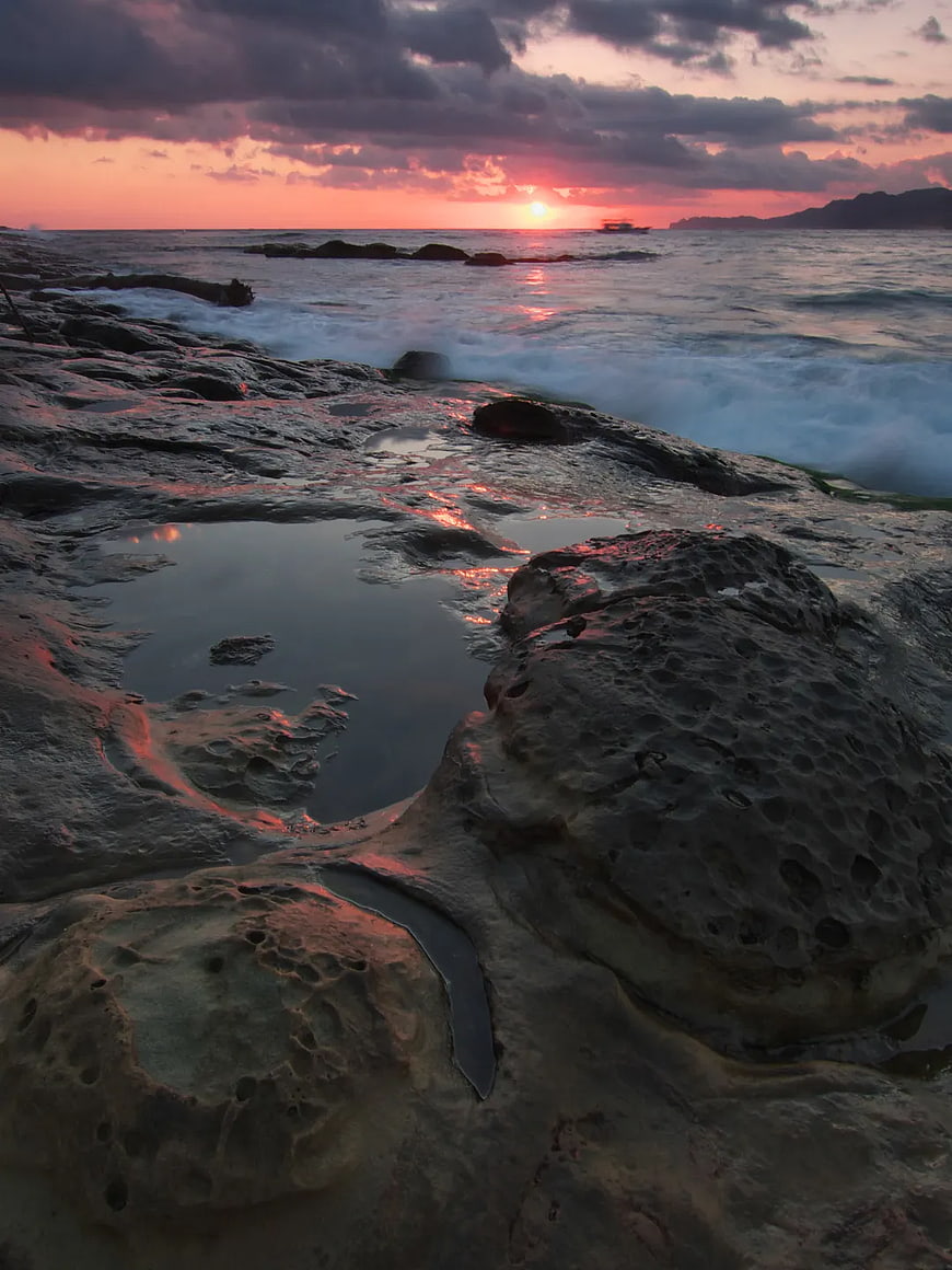 Dramatic Sunset Over Rocky Coastal Tide Pools