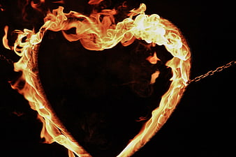 Flaming Heart Symbol Burning Against Black Background