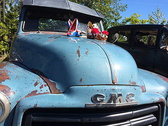 Vintage Blue GMC Truck with Decorative Shoes on Hood