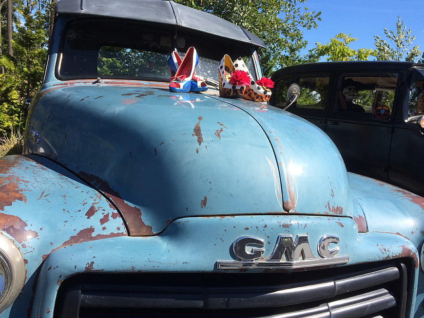 Vintage Blue GMC Truck with Decorative Shoes on Hood