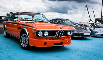 Orange BMW 3.0 CSL Classic Car Parked On Blue Surface