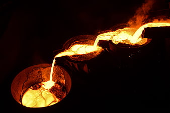 Molten metal pouring in industrial furnace