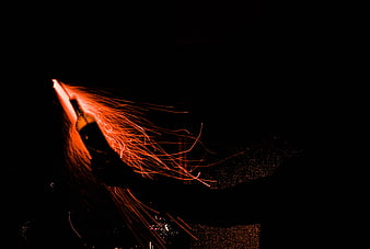 Sparks Flying from a Bottle in the Dark Night