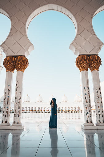 Woman in Abaya Standing in Grand Mosque Courtyard