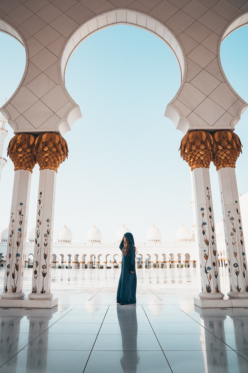 Woman in Abaya Standing in Grand Mosque Courtyard