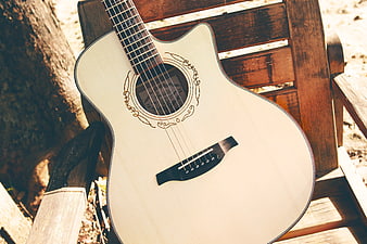 White Acoustic Guitar on Wooden Bench Outdoors
