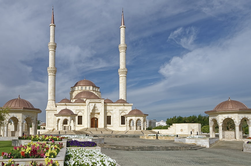 Sultan Qaboos Grand Mosque Exterior With Minarets And Gardens
