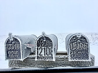 Snow-covered rural mailboxes in winter landscape
