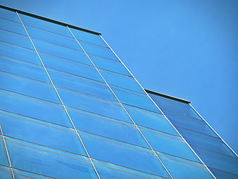 Modern Glass Office Building Facade Against Blue Sky
